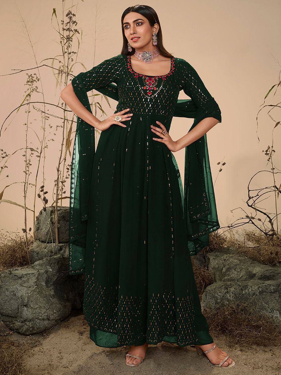 Woman wearing dark green embroidered ethnic gown with dupatta, traditional jewelry