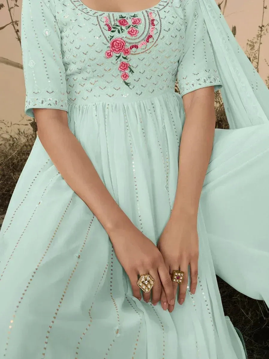 Pastel blue embroidered ethnic gown with floral detailing and statement rings