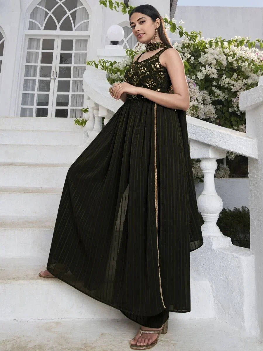 Woman wearing a stylish black embroidered ethnic gown with gold details outdoors