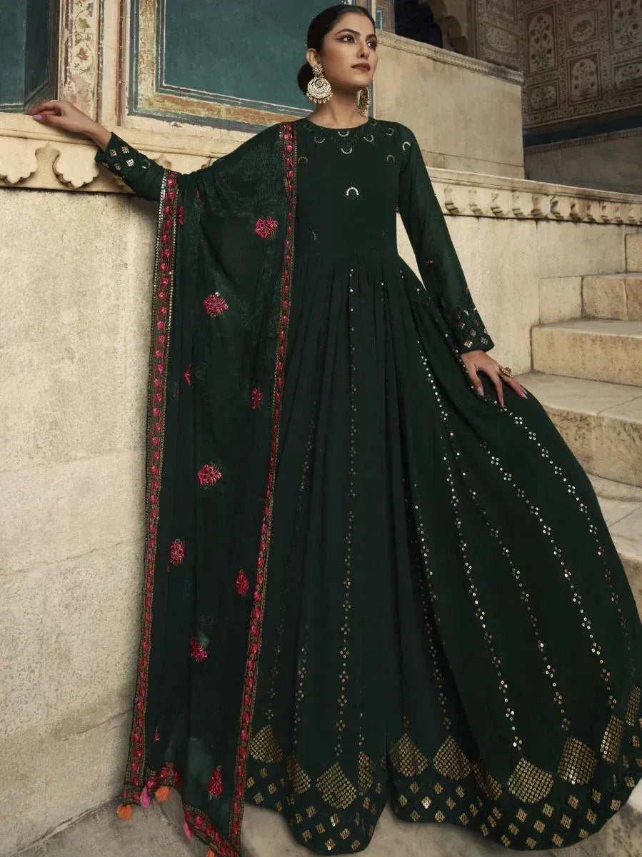 Elegant dark green ethnic gown with floral embroidery and sequin detailing, perfect for festive occasions.