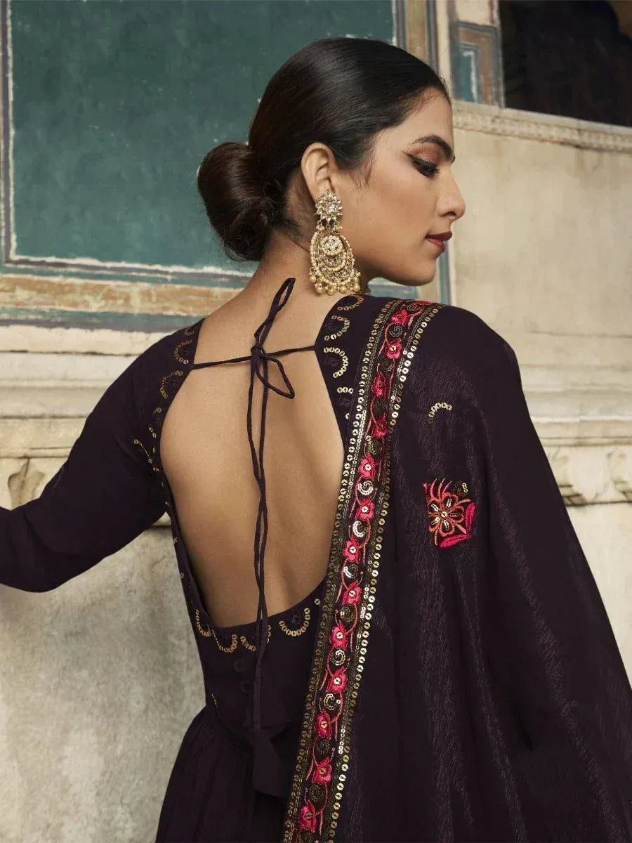 Elegant black ethnic gown with back tie-up, pink & gold embroidery, and statement earrings for festive occasions.