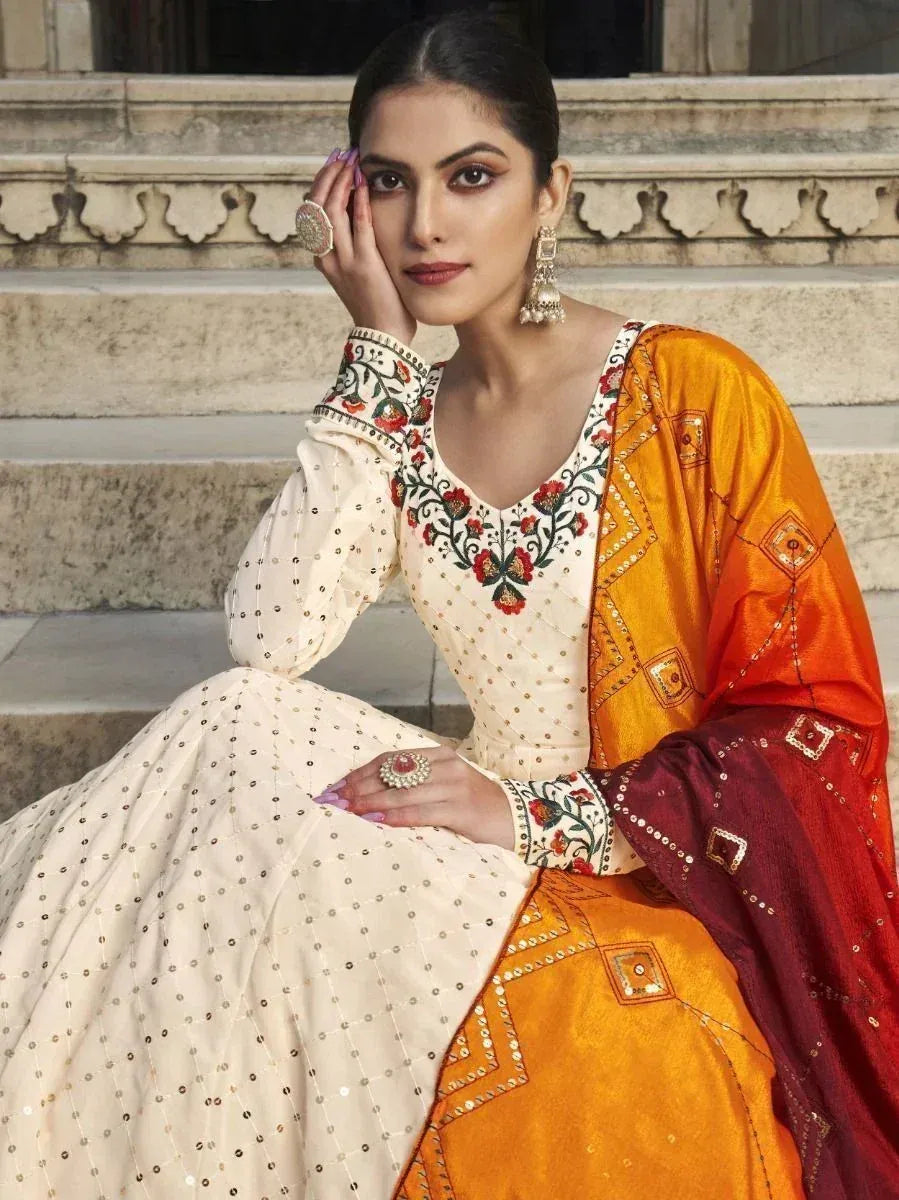 Elegant cream embroidered lehenga choli with orange dupatta, perfect for Indian ethnic occasions