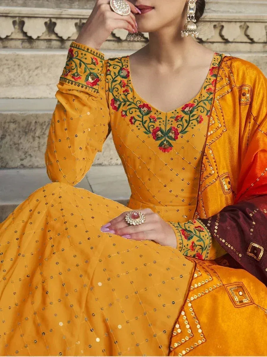 Yellow embroidered ethnic salwar kameez with floral design and mirror work, perfect for Indian festive wear
