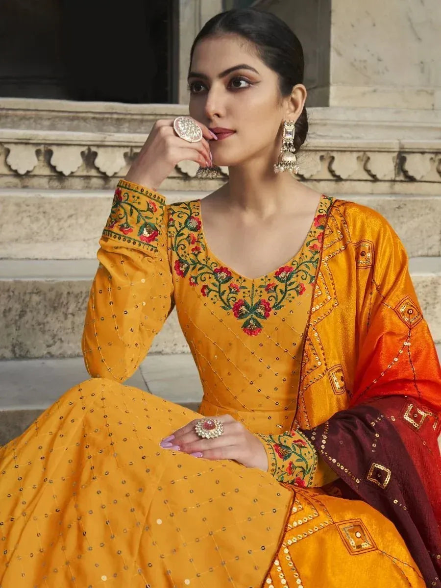 Yellow embroidered ethnic gown with floral detailing, perfect for Indian weddings and festive occasions