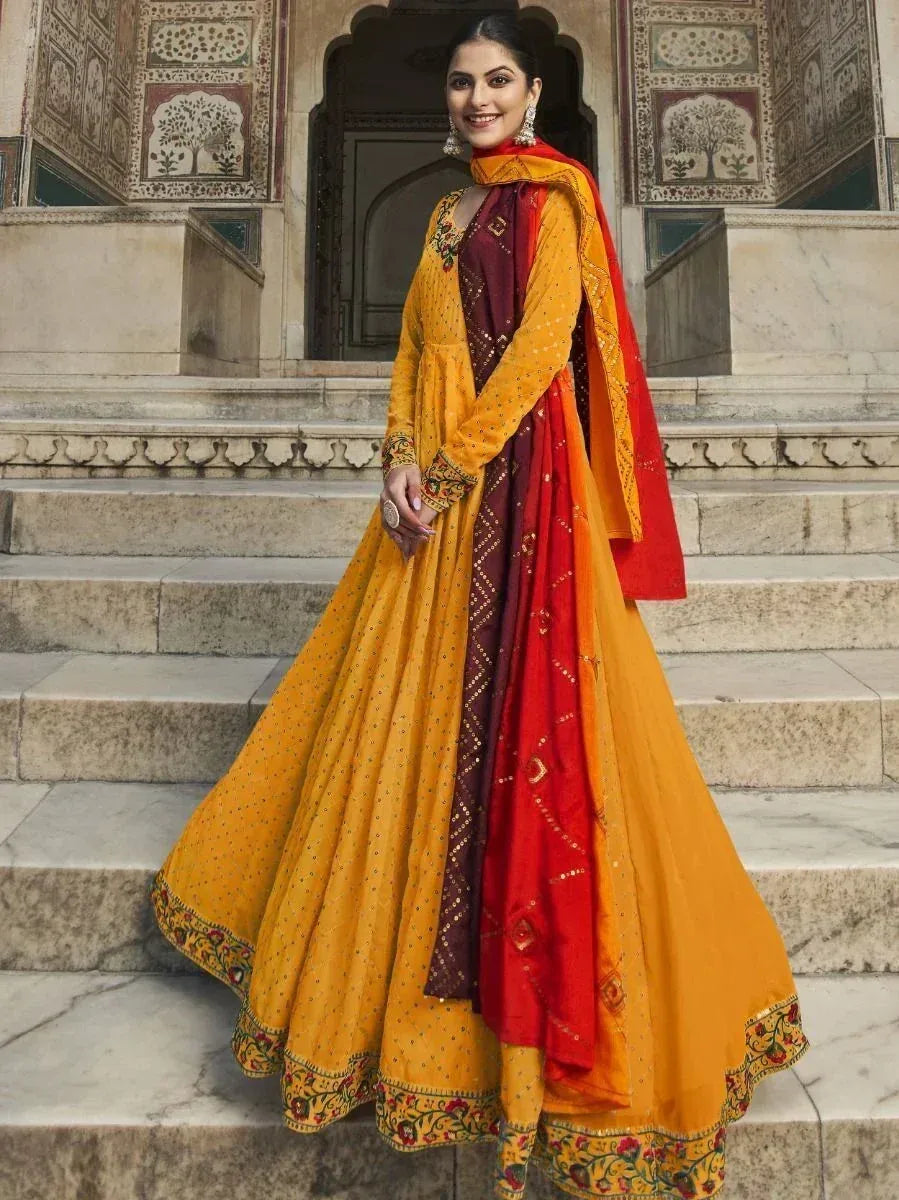 Yellow and red ethnic anarkali suit with embroidery, perfect for Indian weddings and festive occasions