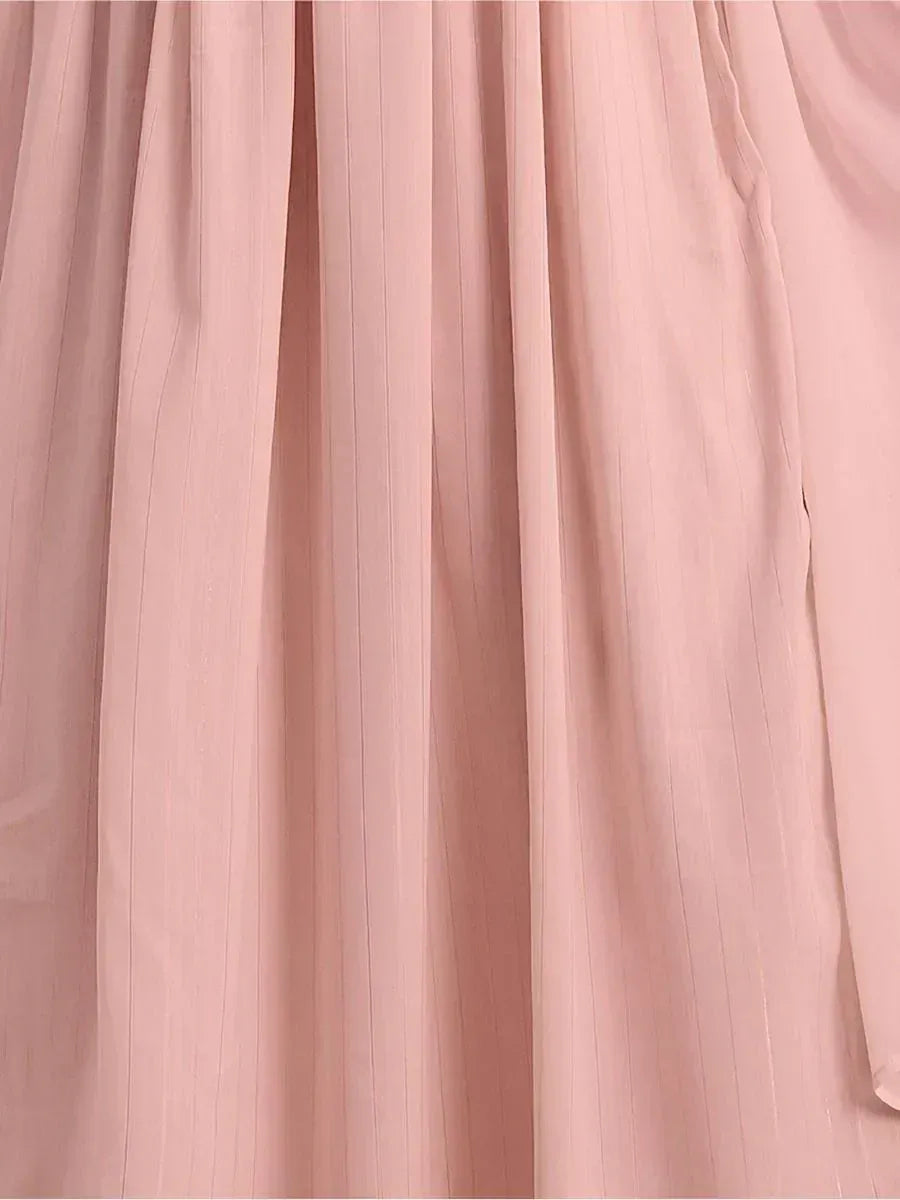 Close-up of light pink pleated ethnic gown fabric with subtle vertical stripes