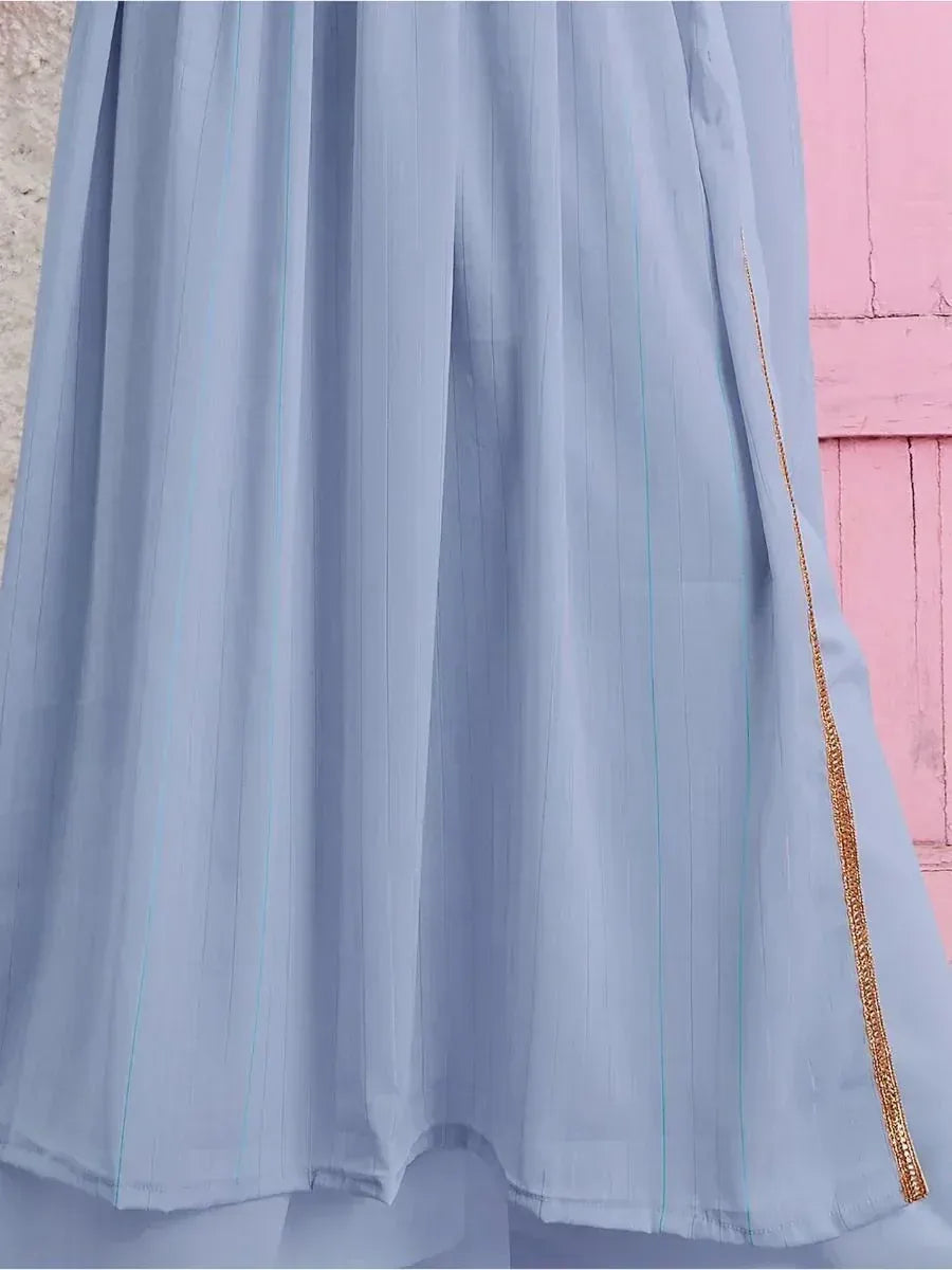 Light blue ethnic gown with subtle gold border and vertical stripes detail