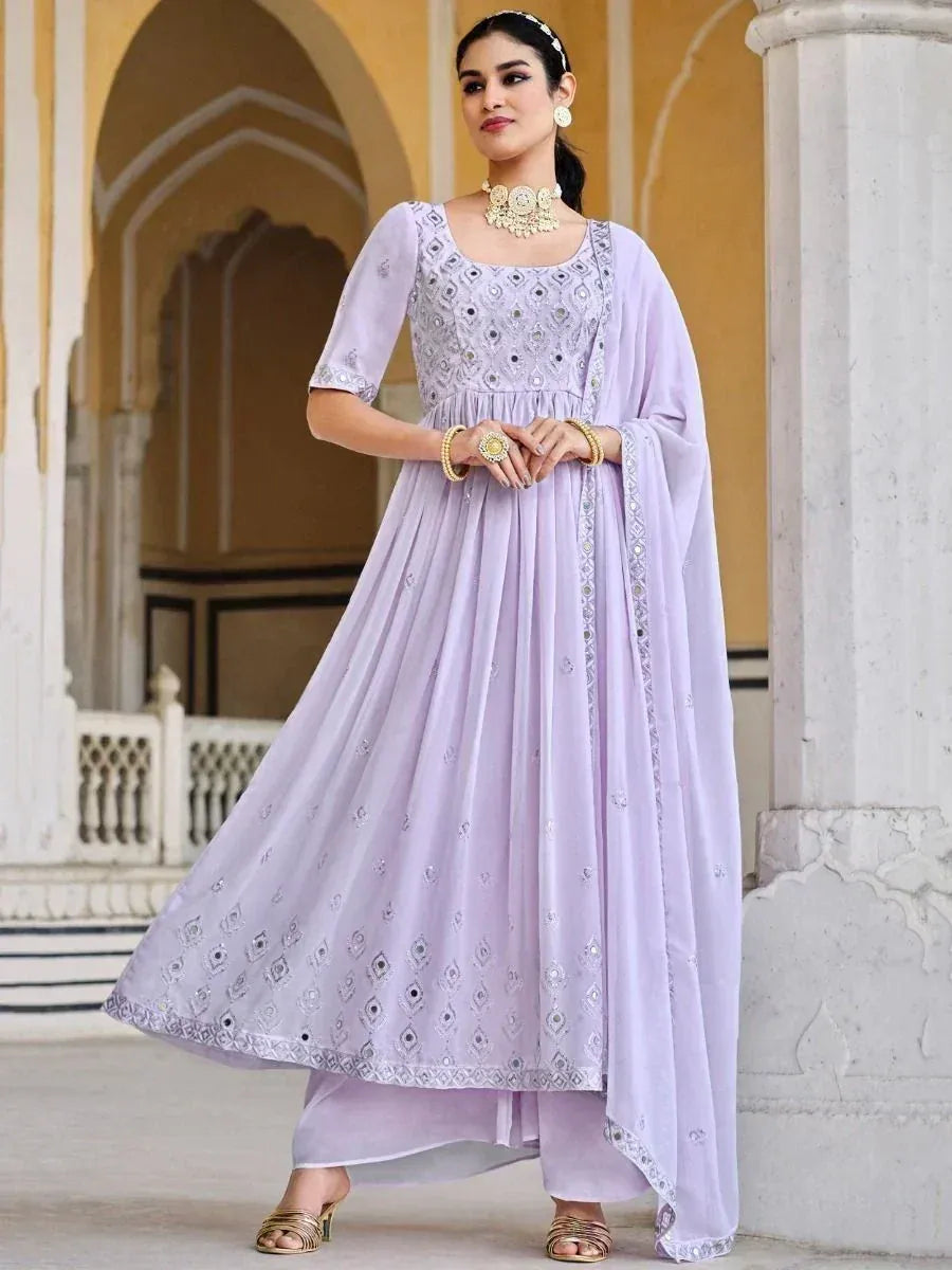 Woman wearing a lavender embroidered ethnic gown with dupatta in traditional setting