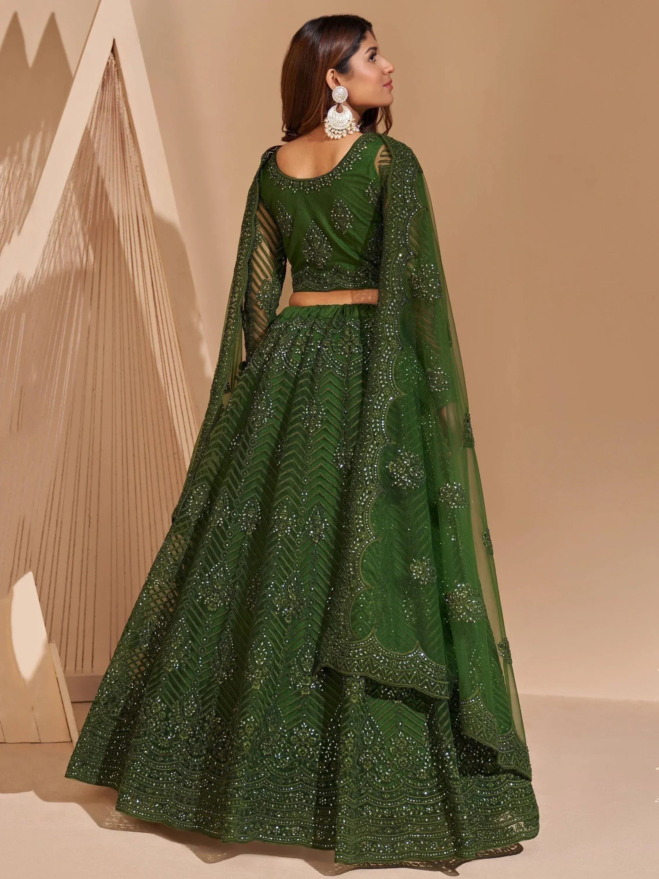 Emerald green embroidered lehenga choli with sheer cape, perfect for Indian weddings and festive occasions.