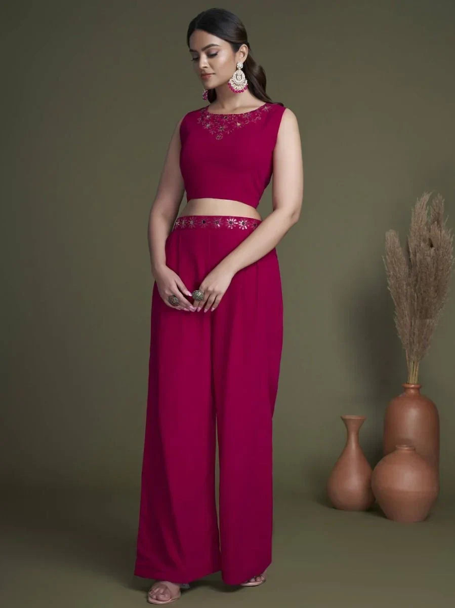 Woman in magenta ethnic crop top and palazzo pants with floral embroidery, traditional earrings