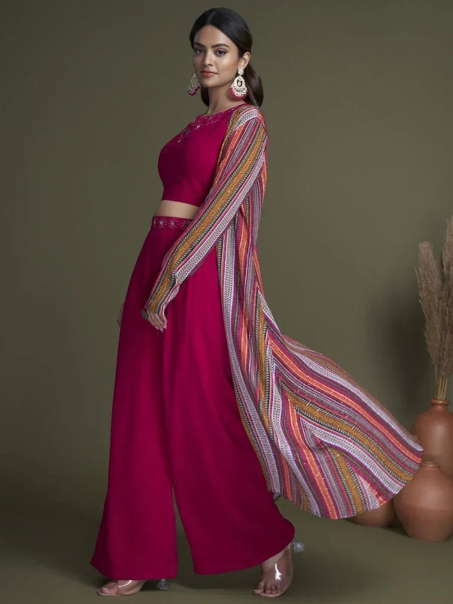 Woman in magenta palazzo suit with embroidered neckline and multicolor striped dupatta