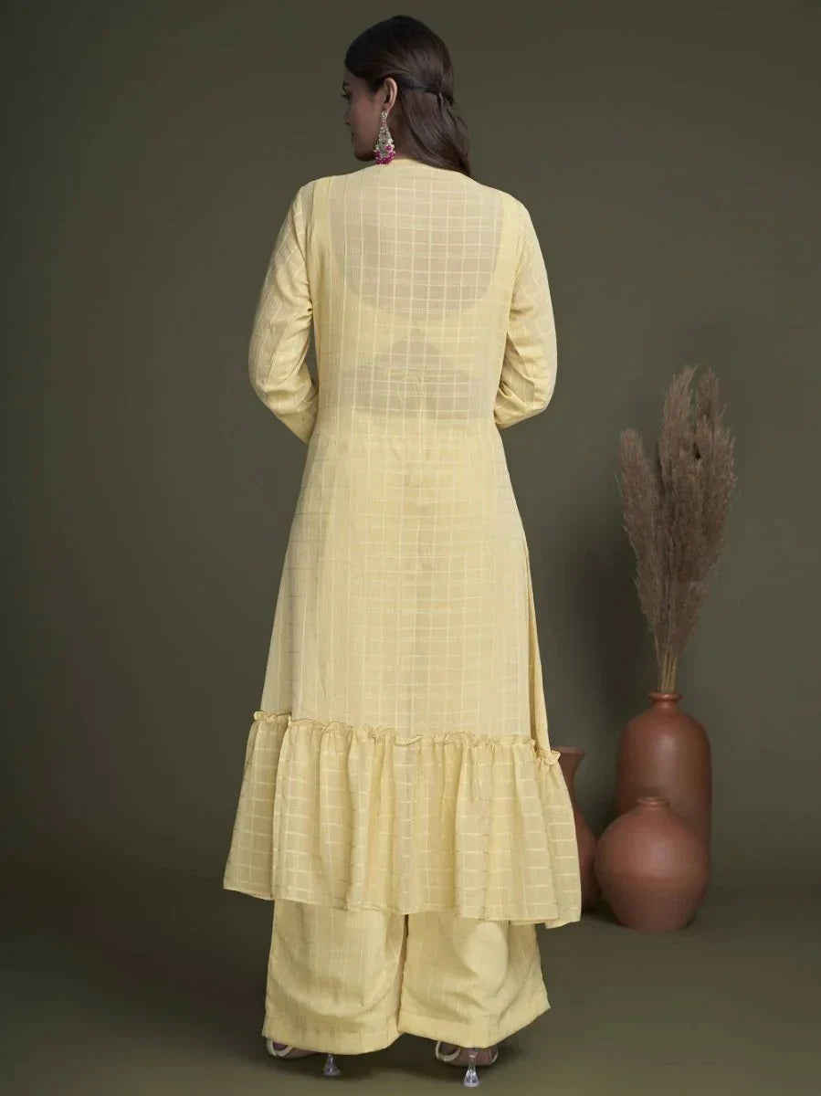 Woman wearing a light yellow checked kurta with ruffle hem and matching palazzo pants