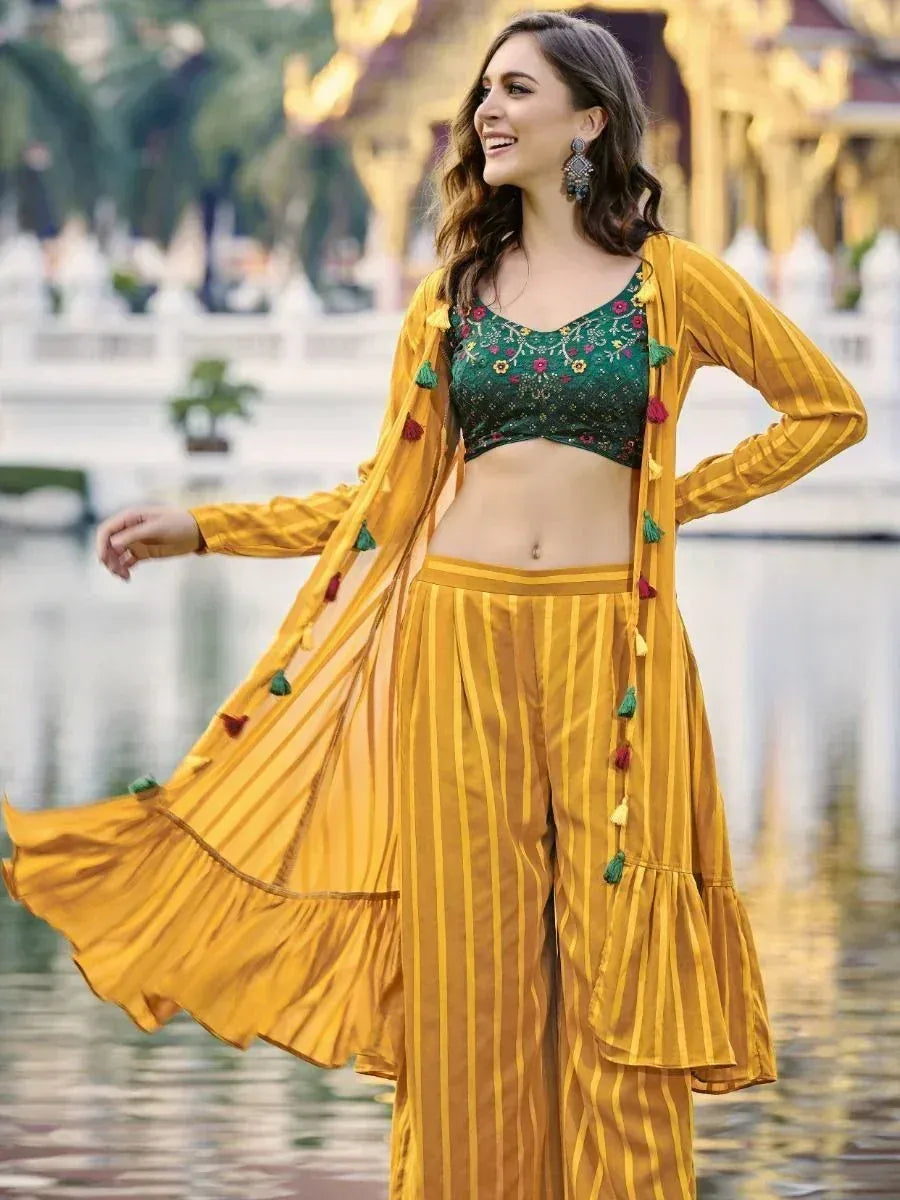 Woman in yellow striped ethnic jacket and pants with green embroidered blouse outdoors