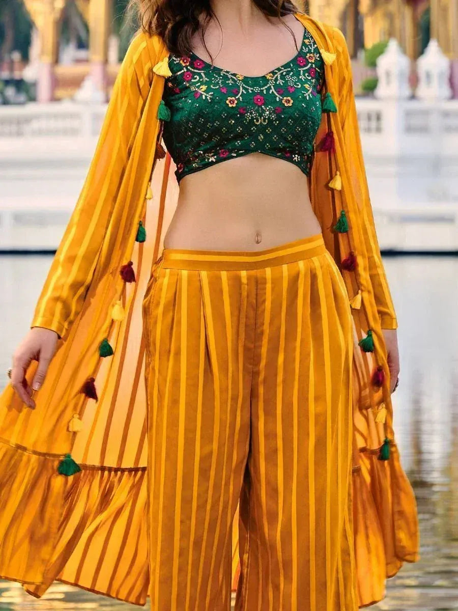 Woman wearing yellow striped ethnic long jacket with palazzo pants and green embroidered crop top