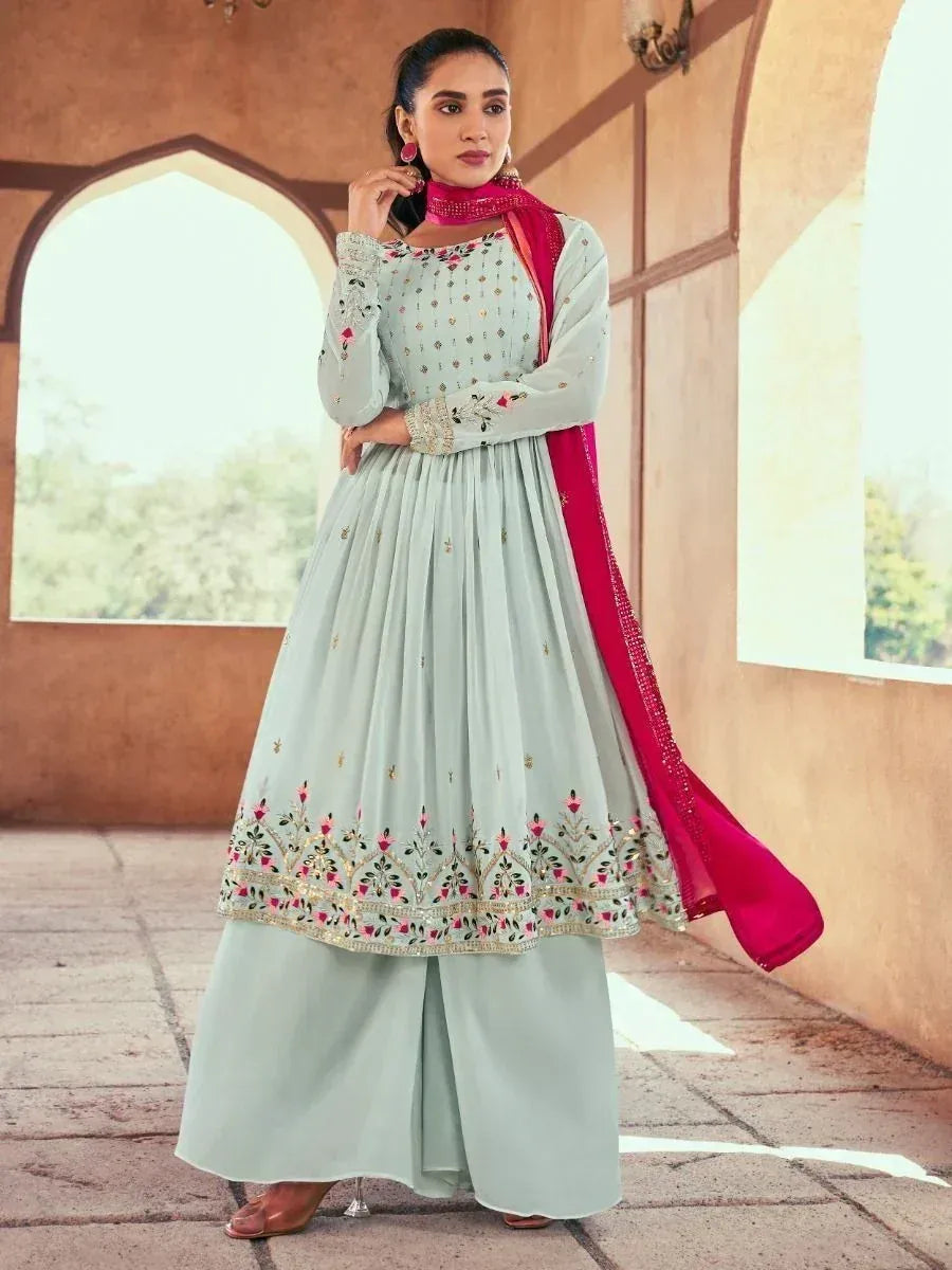 Woman wearing pastel green embroidered palazzo suit with pink dupatta, Indian ethnic wear