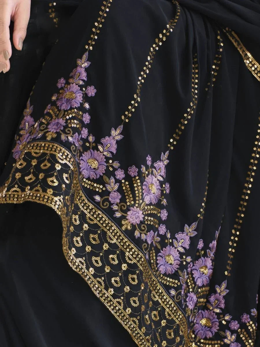Black saree with gold sequins and purple floral embroidery detail