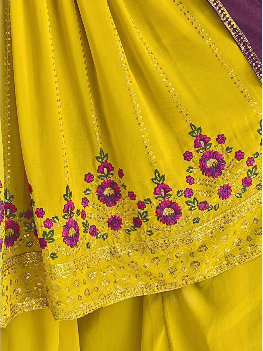 Vibrant yellow ethnic saree with purple floral embroidery and gold sequin detailing, perfect for Indian festive occasions.