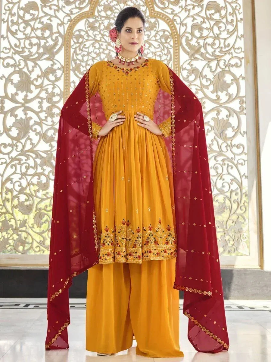 Woman wearing mustard yellow embroidered palazzo suit with maroon dupatta, traditional Indian outfit