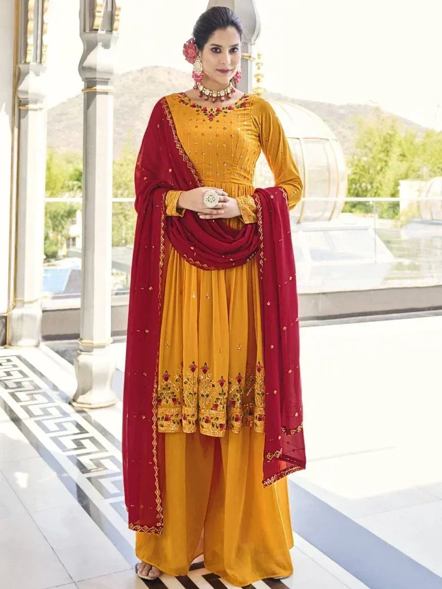 Woman in mustard yellow embroidered salwar kameez with maroon dupatta, traditional Indian ethnic wear