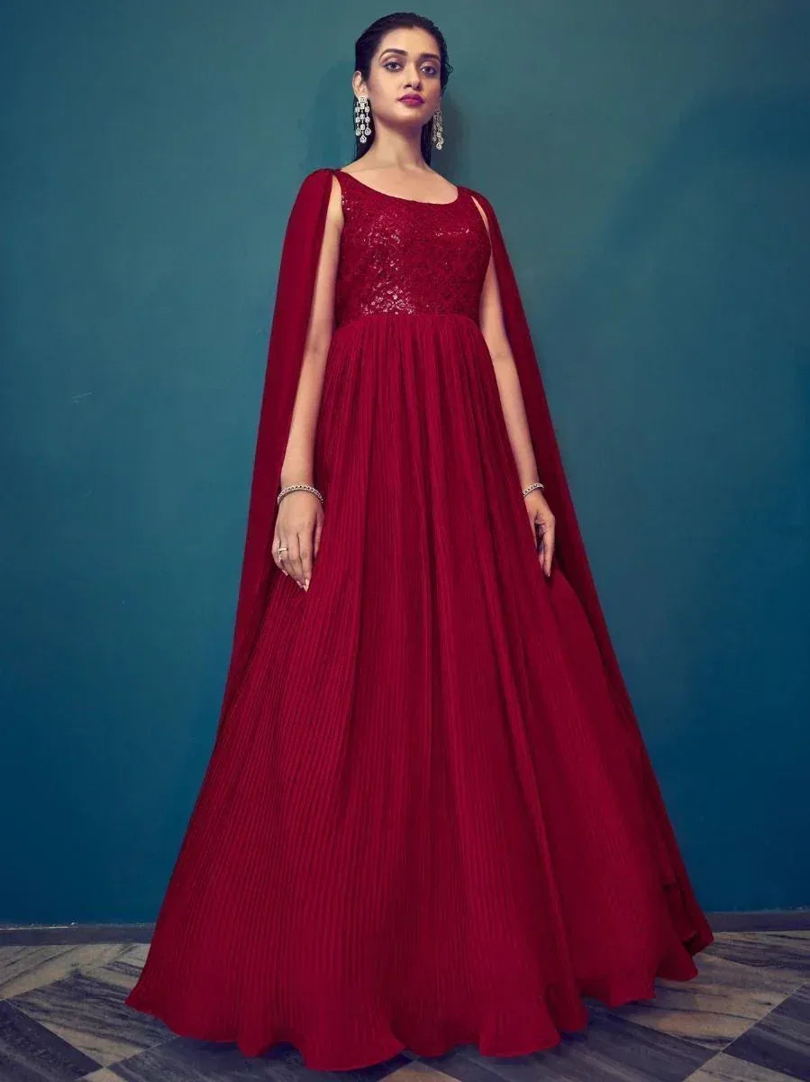 Red ethnic gown with cape, pleated skirt, and lace bodice for Indian occasions