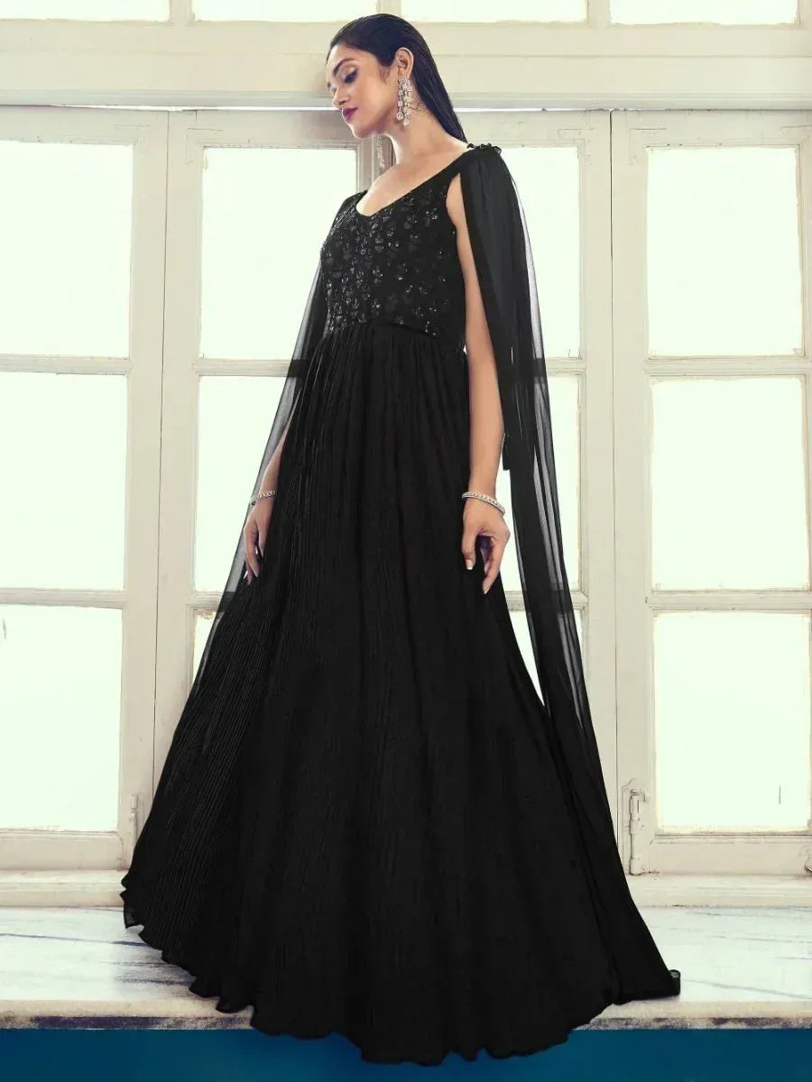 Elegant black ethnic gown with sequin bodice and sheer cape, perfect for Indian evening events.
