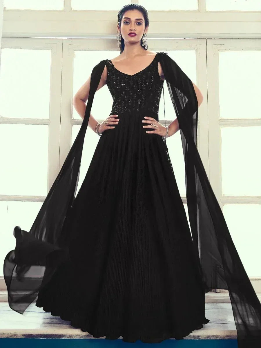Black ethnic gown with sequin bodice and sheer cape sleeves, perfect for evening events