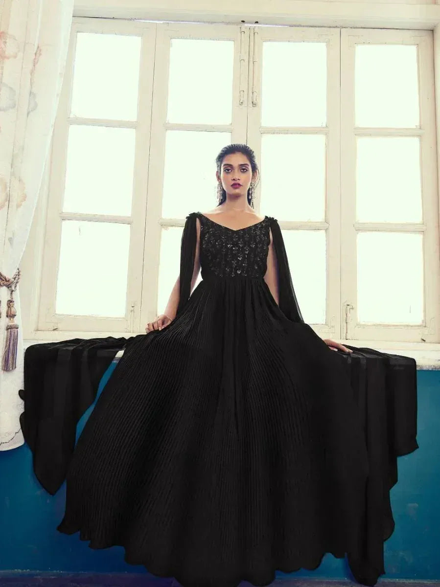 Black ethnic gown with cape sleeves and pleated skirt, perfect for Indian occasions