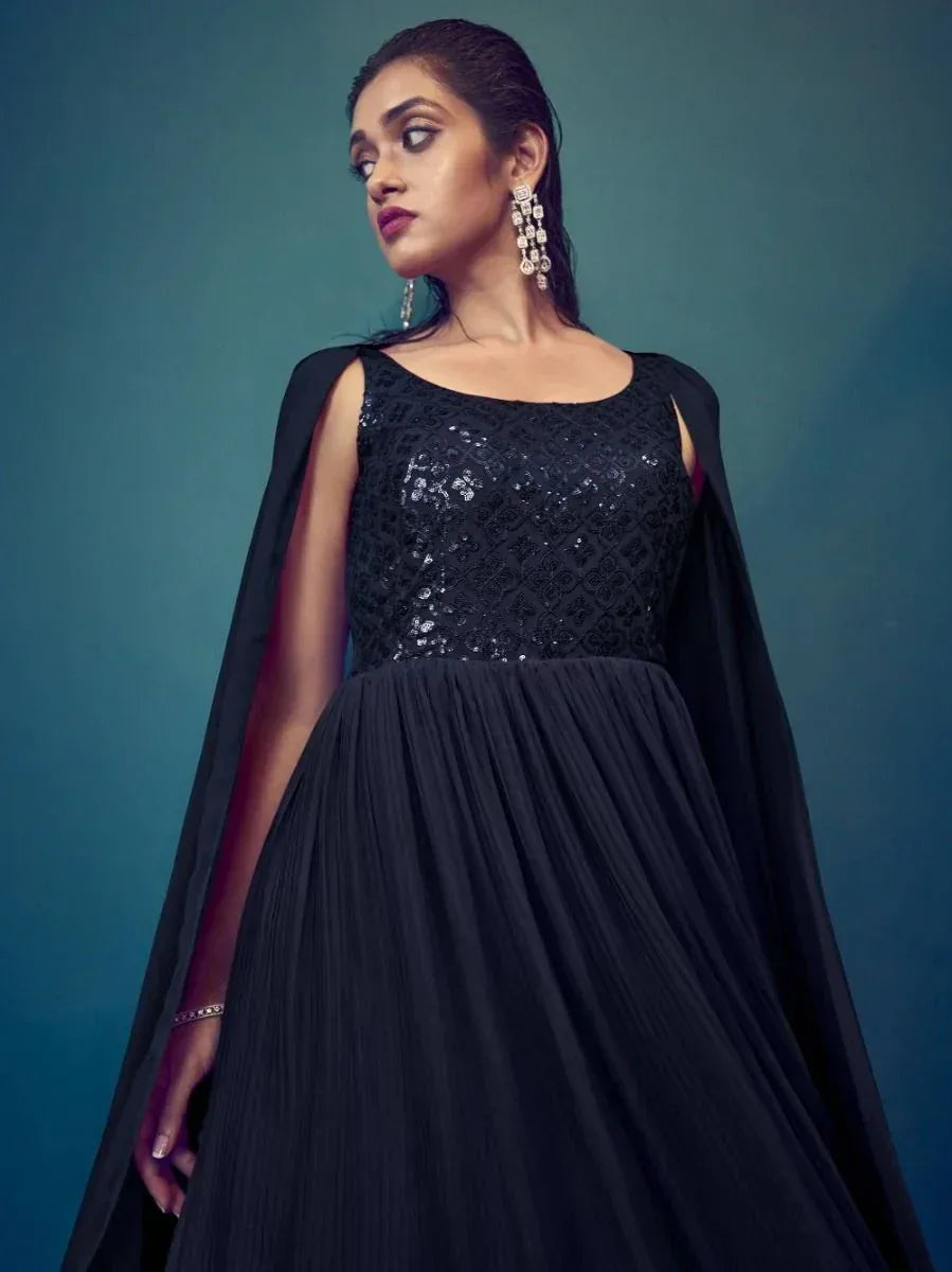 Woman wearing elegant black sequined ethnic gown with statement earrings