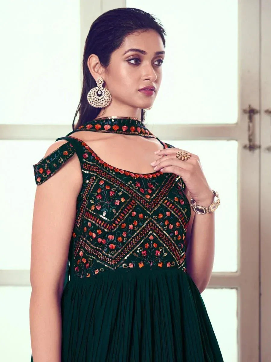 Emerald green embroidered ethnic gown with cold shoulder design and floral motifs, perfect for Indian occasions.