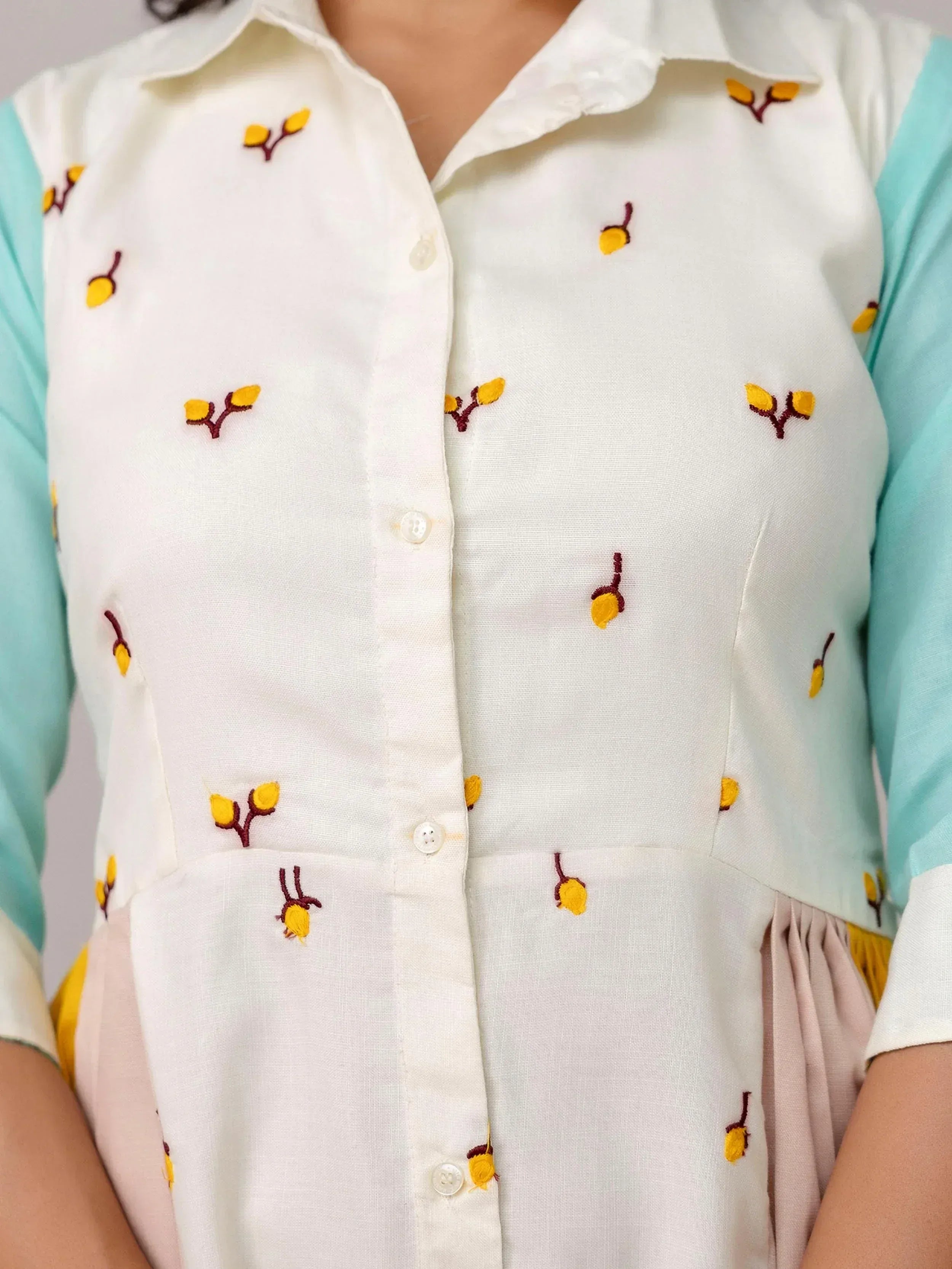 White embroidered kurta with yellow floral motifs and mint sleeves, ethnic wear for women