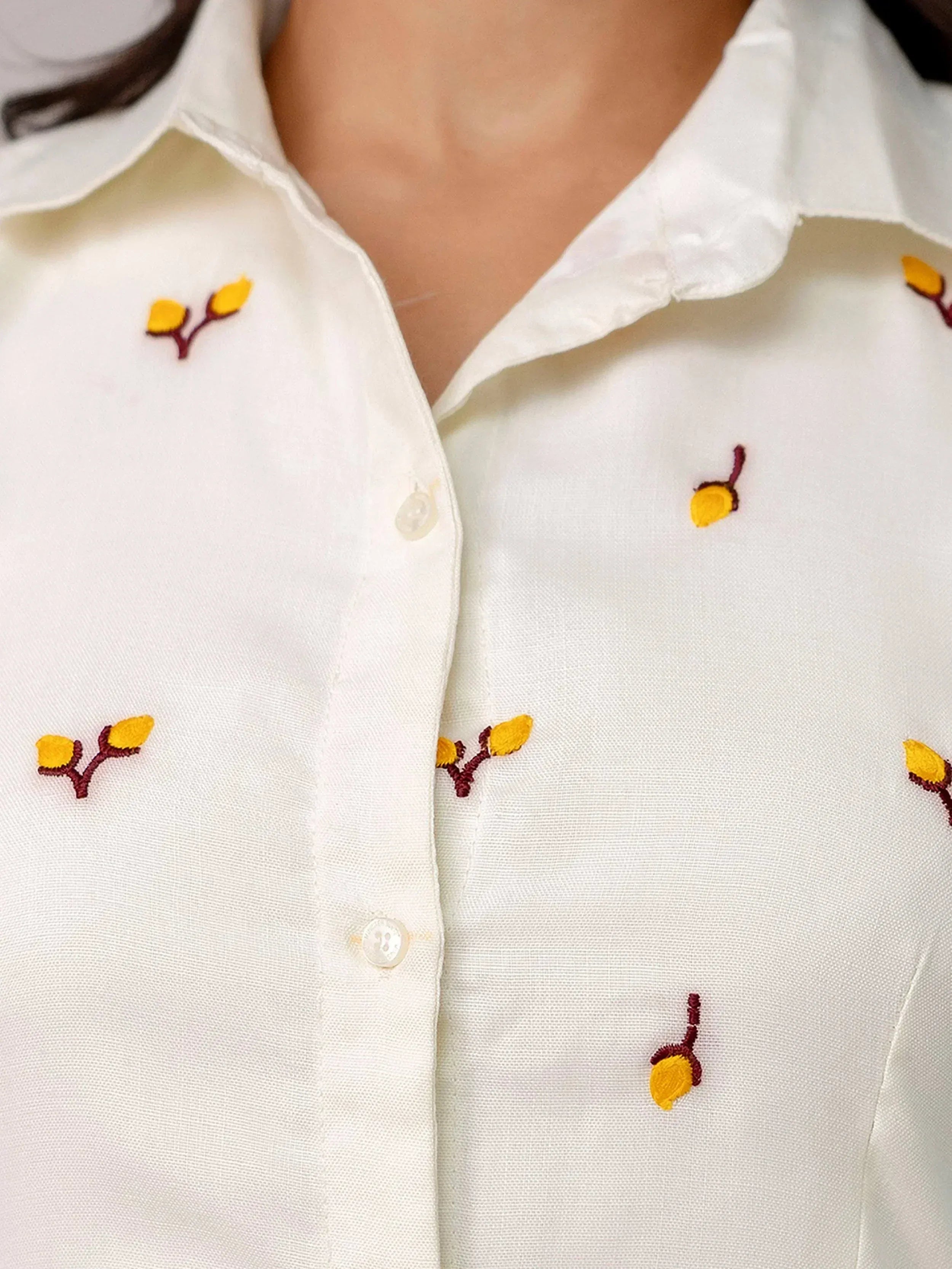 White embroidered shirt with yellow floral motifs, perfect for ethnic wear
