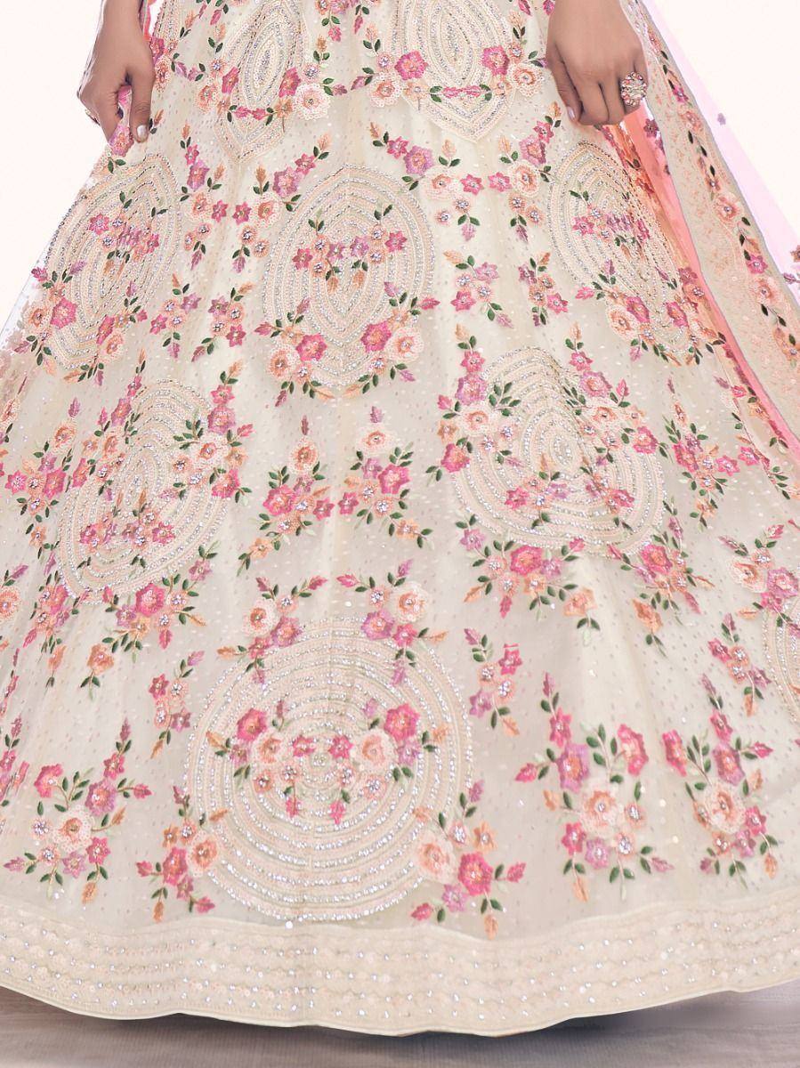 Elegant ivory lehenga with pink floral embroidery and sequin work, perfect for Indian weddings and festivals.