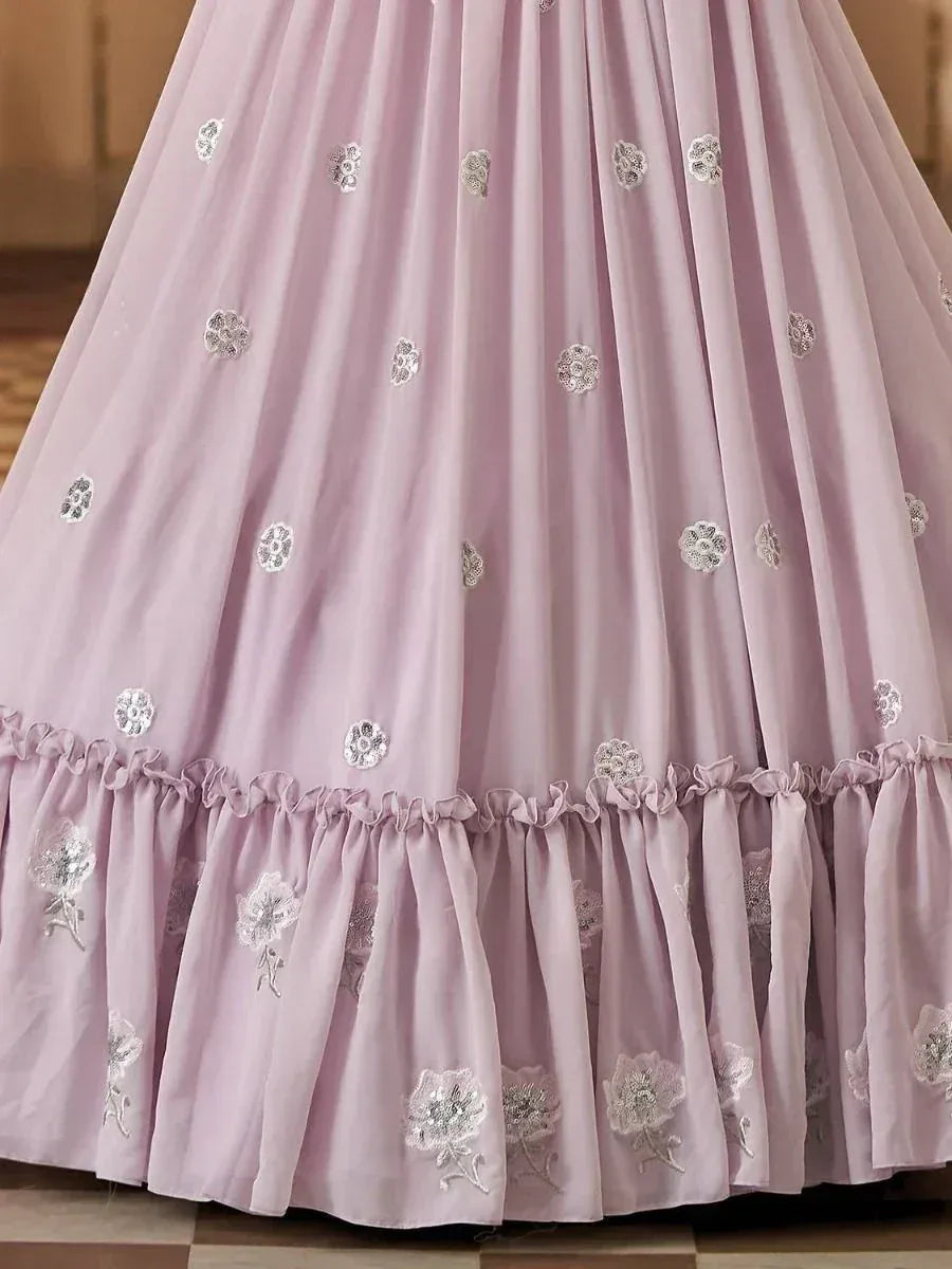 Lavender ethnic gown with silver floral embroidery and ruffled hem, perfect for Indian occasions