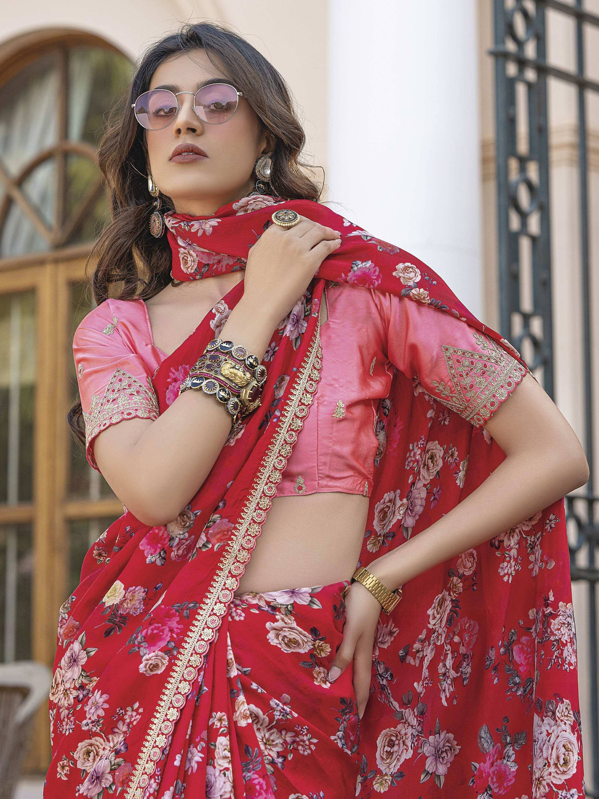 Woman in red floral saree with pink blouse, gold embroidery, and statement jewelry for ethnic wear