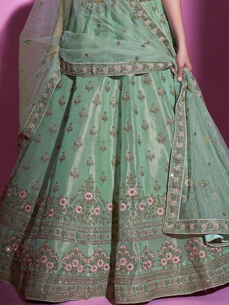 Mint green designer lehenga choli with floral embroidery and net dupatta, perfect for Indian ethnic wear occasions.