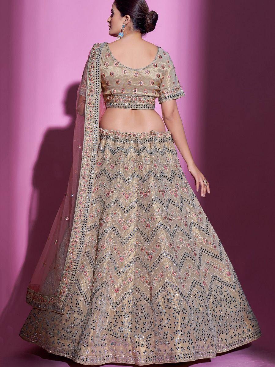 Beige embroidered lehenga choli with mirror work and floral motifs, perfect for Indian ethnic occasions