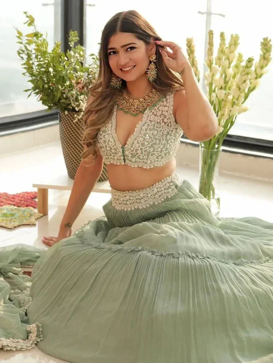 Mint green designer lehenga choli with lace blouse and pleated skirt, perfect for Indian ethnic wear events
