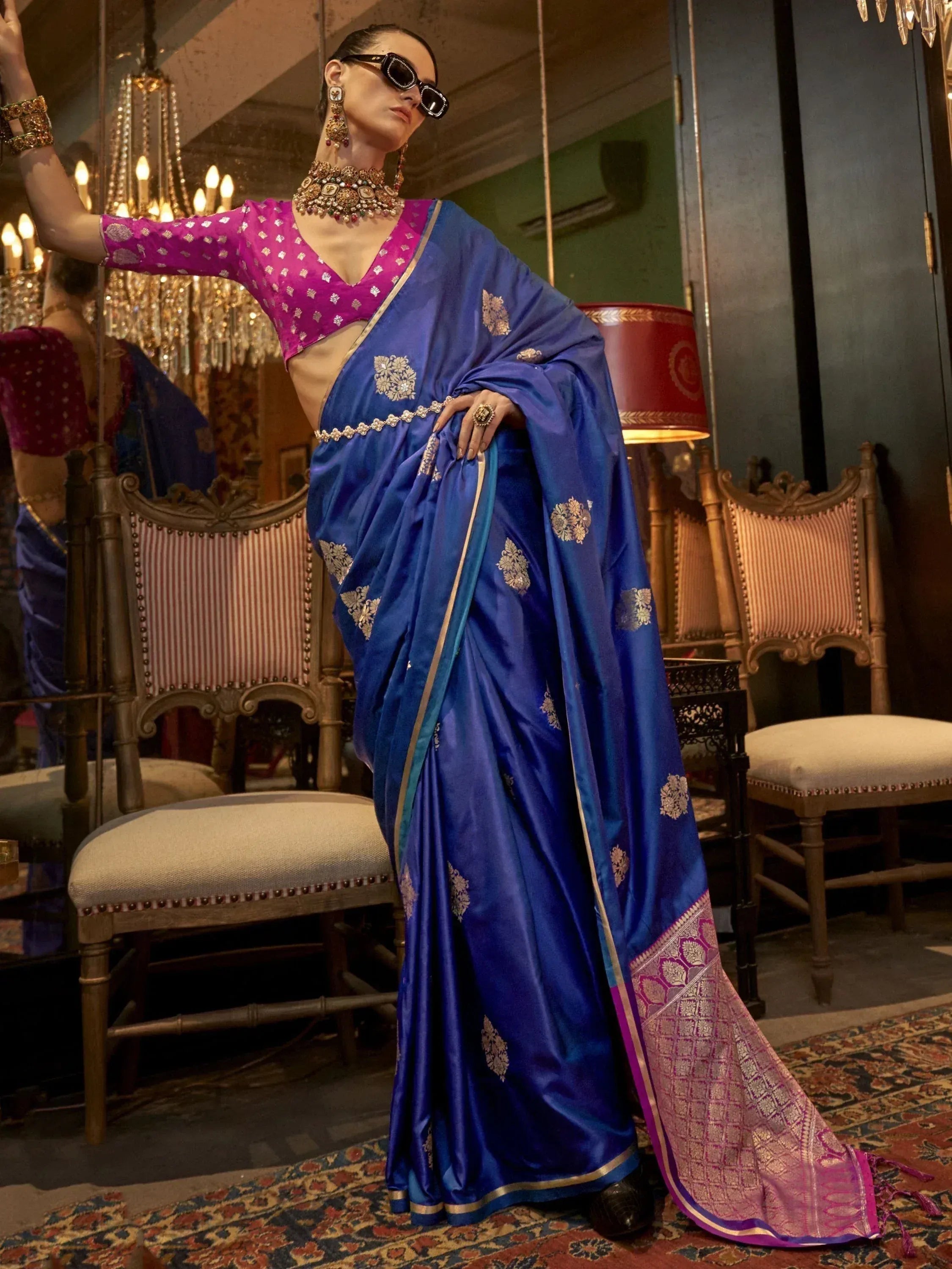 Royal blue silk saree with gold floral motifs, paired with pink blouse, perfect for Indian ethnic occasions.
