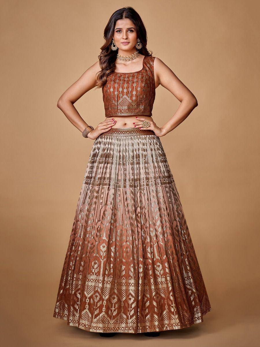 Elegant brown and gold embroidered lehenga choli with geometric patterns, perfect for Indian ethnic occasions.