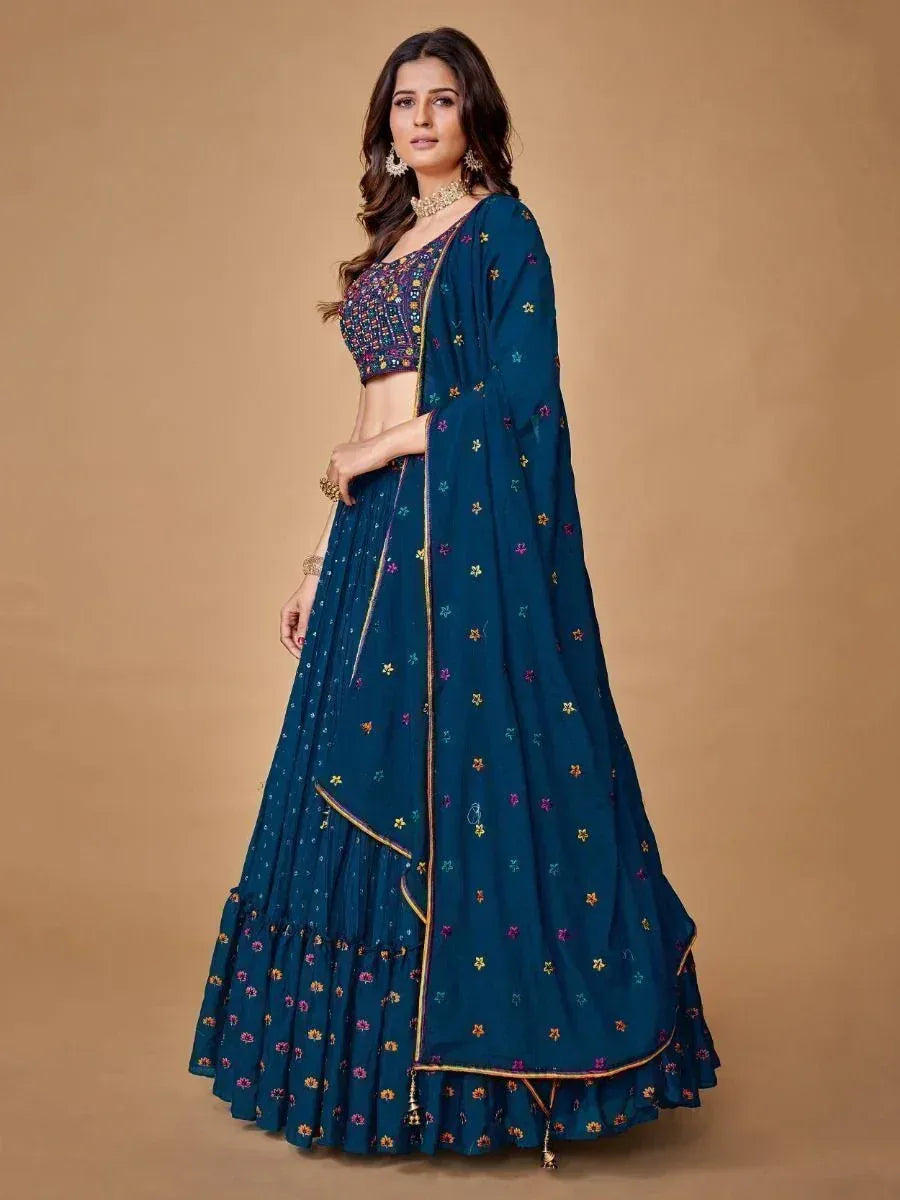 Teal embroidered lehenga choli with floral motifs and gold trim, perfect for Indian ethnic occasions