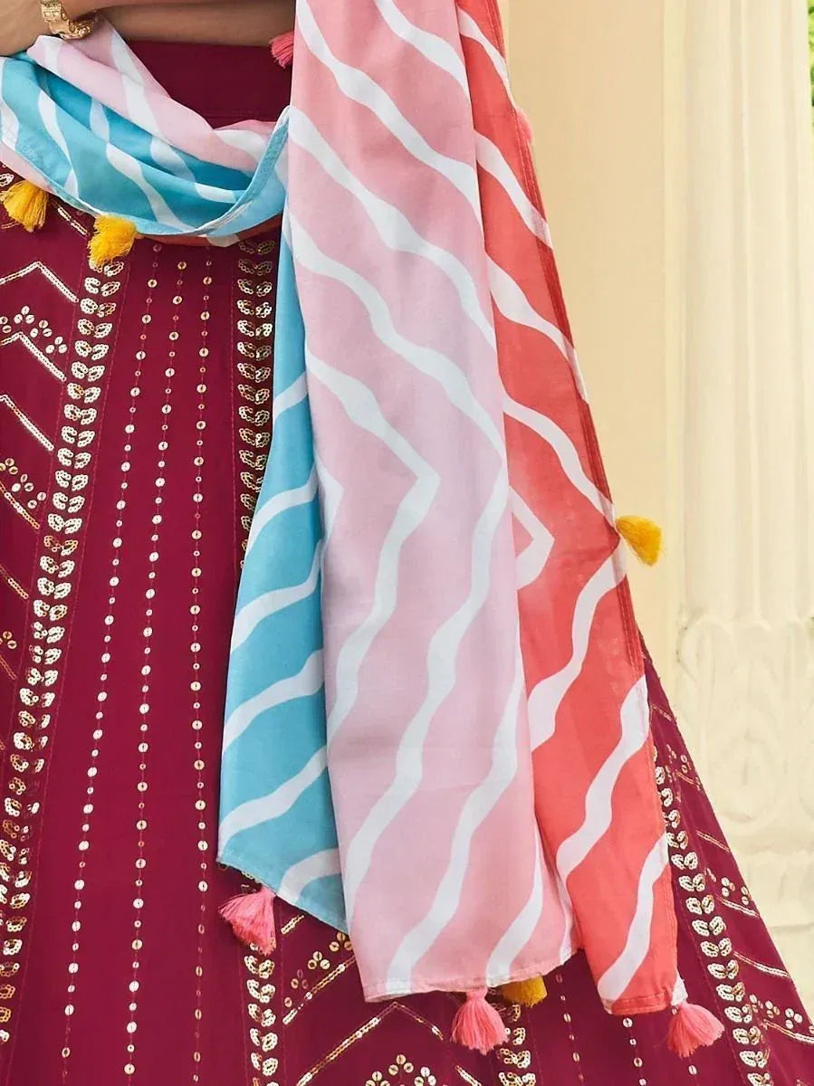 Maroon ethnic dress with sequin embroidery and colorful striped dupatta with tassels