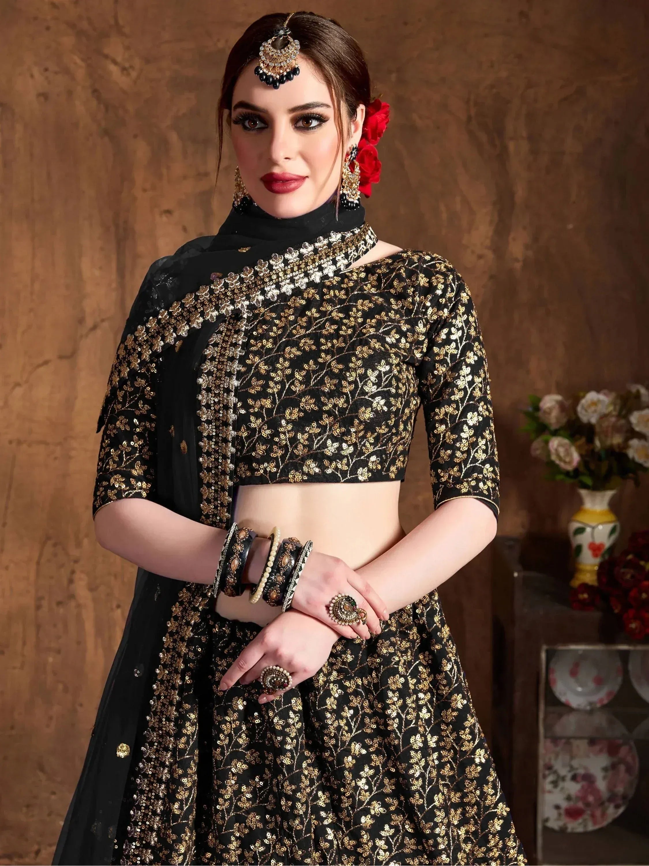 Black and gold embroidered lehenga choli with matching dupatta, traditional Indian ethnic wear for women.