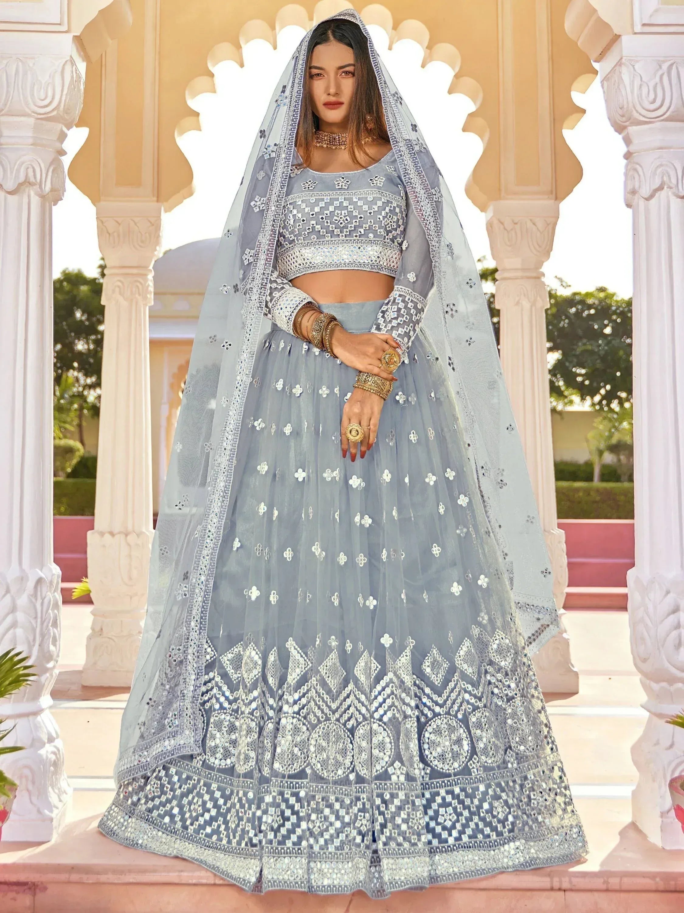 Light blue designer lehenga choli with mirror work and dupatta, perfect for Indian ethnic occasions