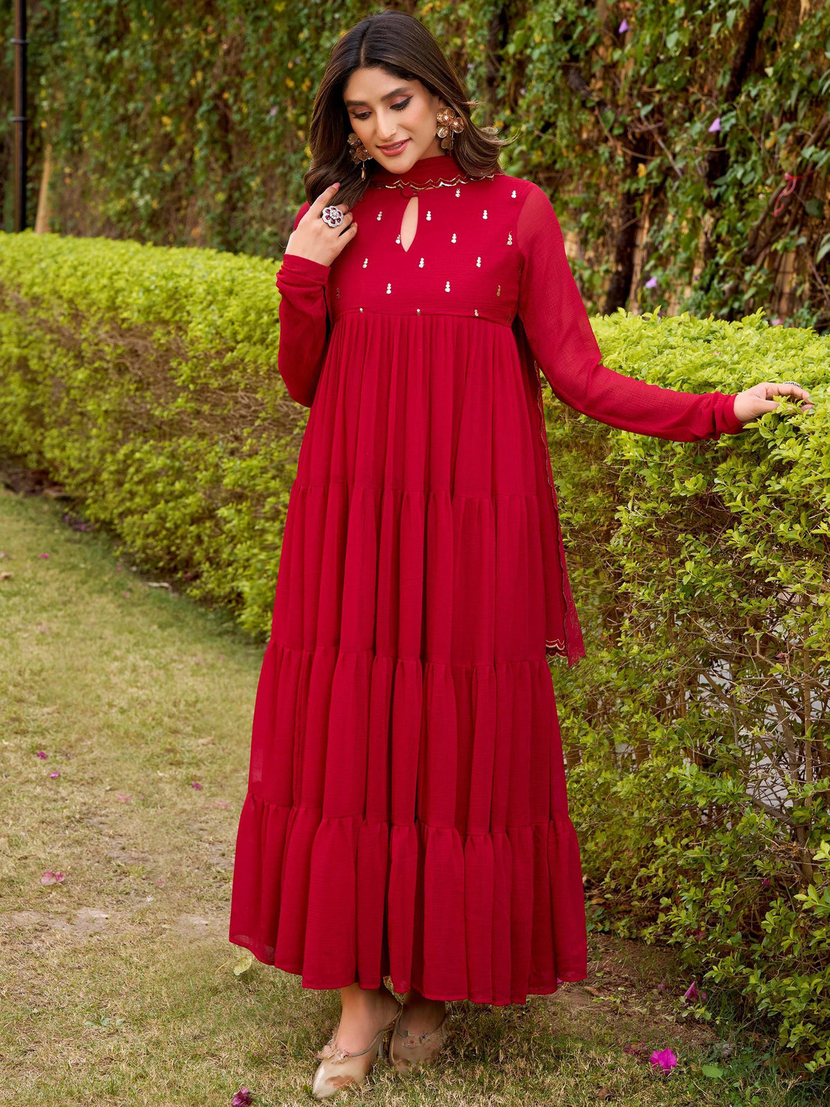 Red ethnic gown with tiered skirt and embellished neckline, perfect for festive occasions