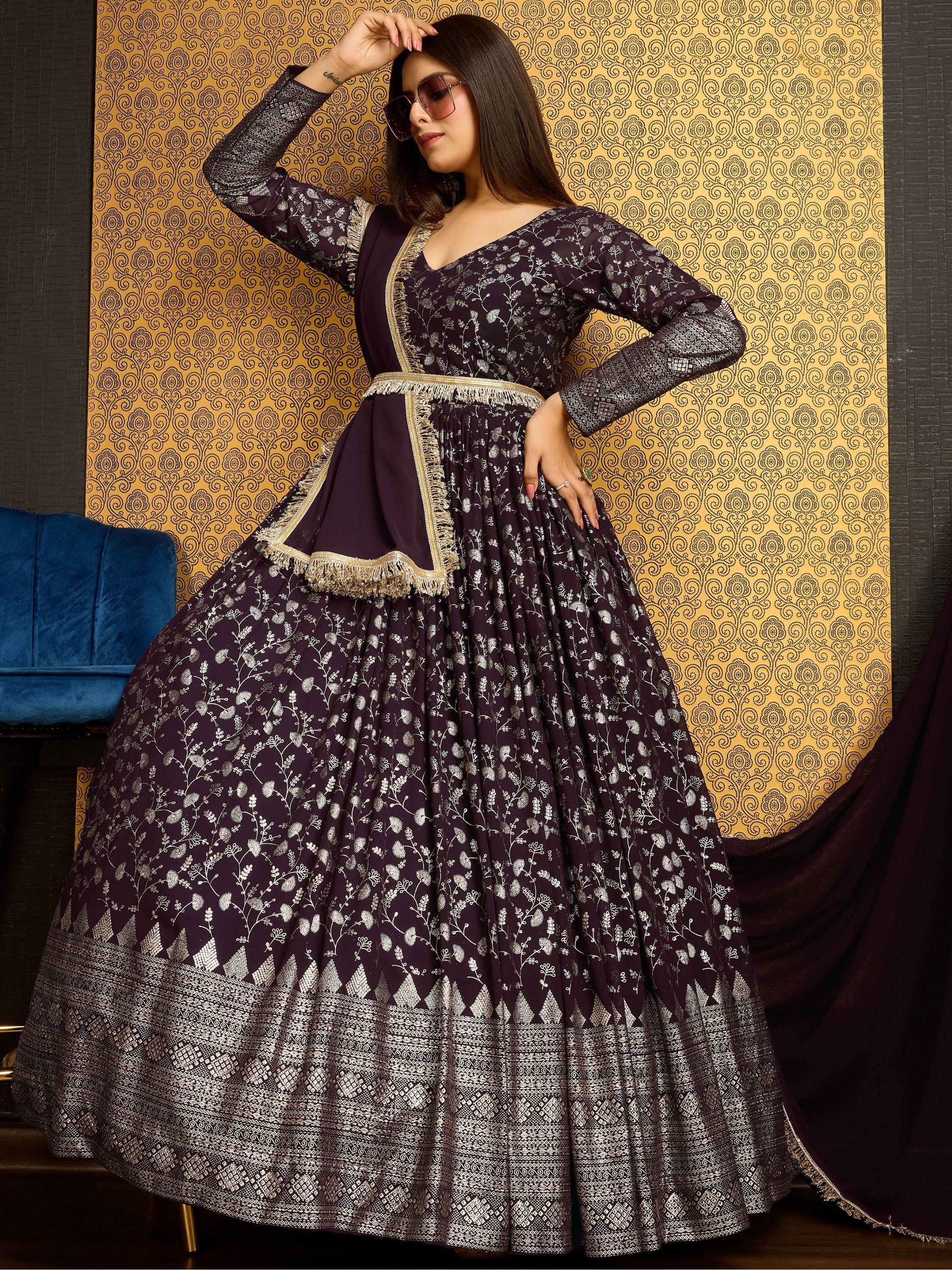 Woman in a purple and silver embroidered long ethnic gown with dupatta, traditional Indian wear