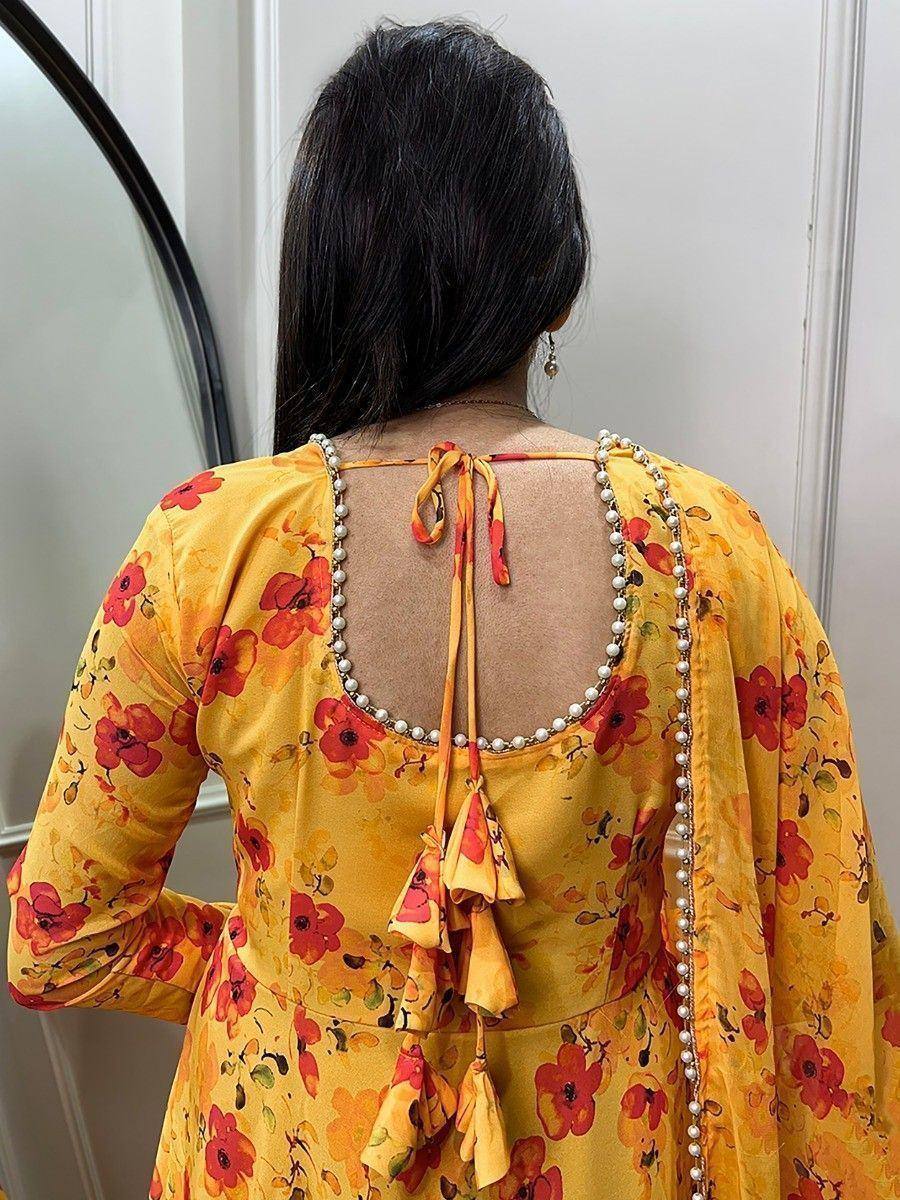 Yellow floral ethnic gown with pearl trim and back tie detail, perfect for Indian occasions
