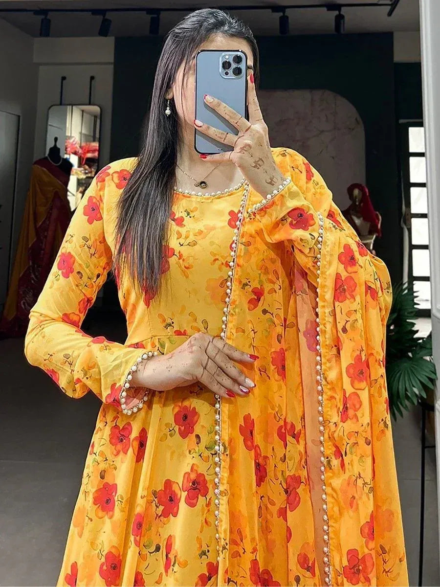Yellow floral printed ethnic gown with pearl detailing, perfect for Indian occasions and festive wear.