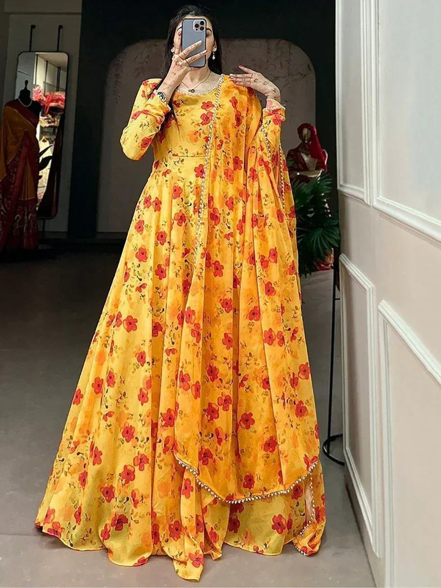 Yellow floral ethnic gown with red print, long sleeves, and pearl trim, perfect for Indian occasions