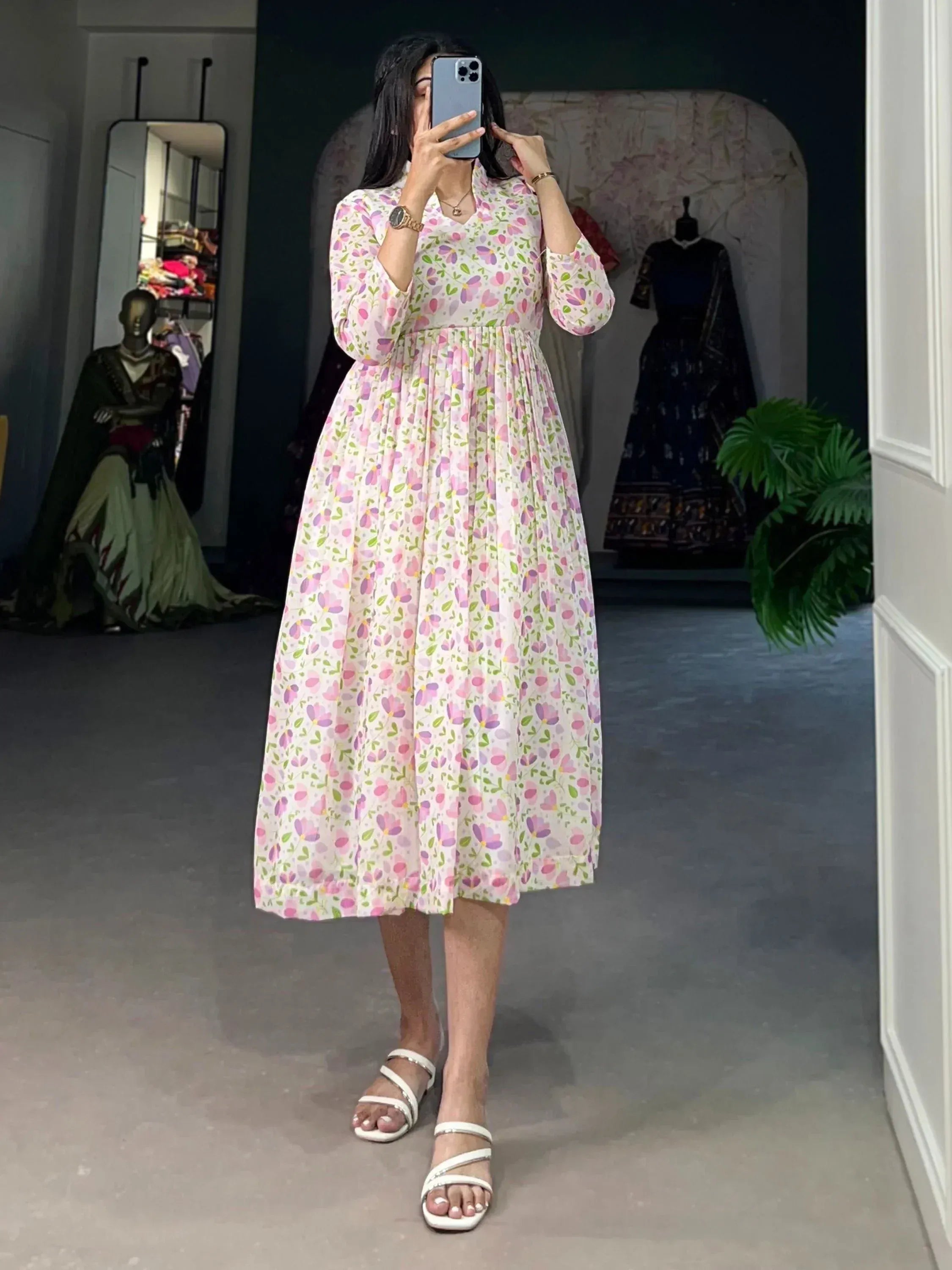 Woman wearing floral print ethnic gown with long sleeves, perfect for Indian occasions and festive wear.