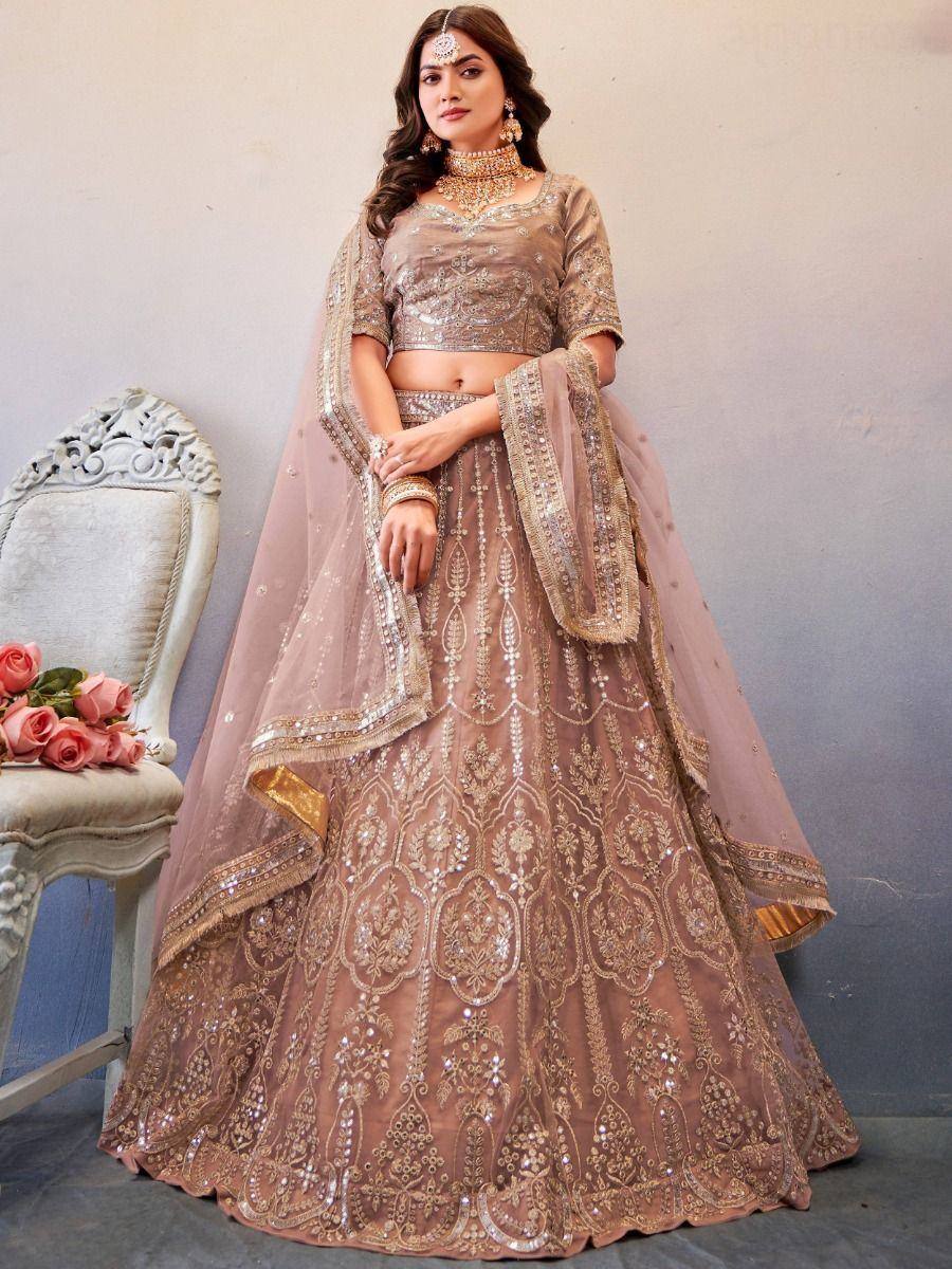 Elegant beige designer lehenga choli with heavy gold embroidery and dupatta, perfect for Indian weddings